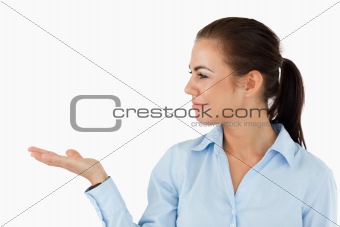 Businesswoman holding something up and looking at it