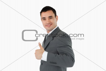 Side view of businessman giving thumb up