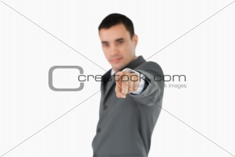Side view of businessman pointing towards camera