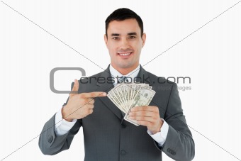 Businessman pointing at bank notes in his hand