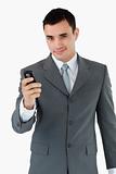 Confident businessman with his cellphone