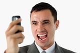 Close up of businessman upset about text message