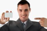 Businessman pointing at business card