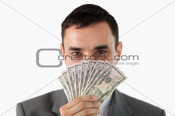 Businessman smelling on banknotes