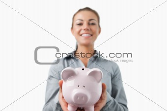Piggy bank being held by bank assistant