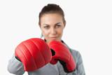 Boxing gloves used to slam by young businesswoman