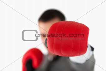 Close up of boxing glove being used to slam by businessman