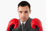 Close up of businessman wearing boxing gloves