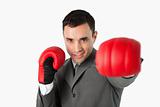 Businessman with boxing gloves on beating