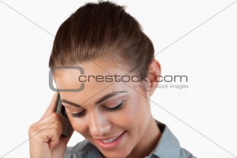 Close up of shy smiling businesswoman on the phone
