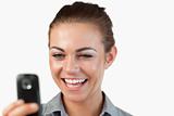 Close up of businesswoman being happy about text message
