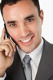 Close up of smiling young businessman on the phone
