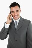 Friendly smiling businessman on the phone