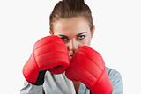 Close up of serious businesswoman with boxing gloves