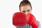 Close up of businesswoman striking with boxing gloves