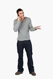 Young male gesturing while on the phone
