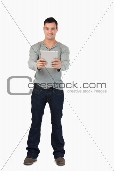 Young male holding his tablet