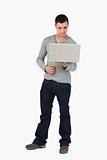 Young male looking at laptop screen