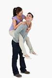 Young female carried piggyback by her boyfriend