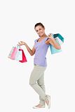 Side view of smiling young female with shopping bags