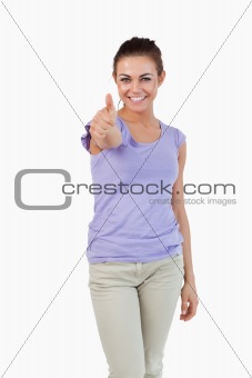 Smiling young female giving thumb up