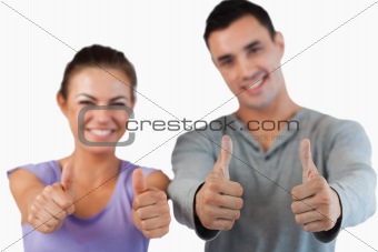 Thumbs up being given by young couple
