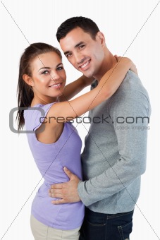 Smiling young couple embracing
