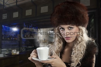 elegant blond girl with cup of tea