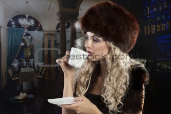 elegant blond girl drinking a cup of tea