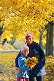 Family in autumn maple park