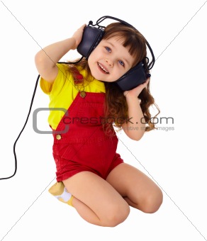 Little girl enjoys music in big headphones