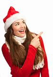 Woman in santa hat pointing to copyspace
