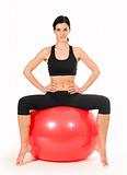 Brunette woman excercising with a pilates ball