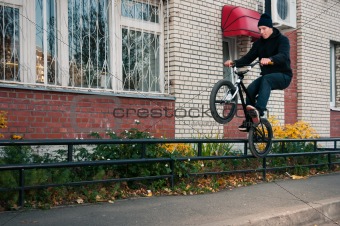 Biker doing icepick grind trick