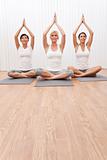 Interracial Group of Three Beautiful Women In Yoga Position