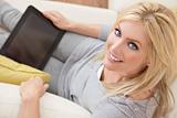 Beautiful  Women Using Tablet Computer At Home on Sofa