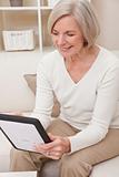 Attractive Senior Woman Using a Tablet Computer