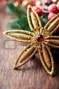 Golden christmas star on rustic wooden background