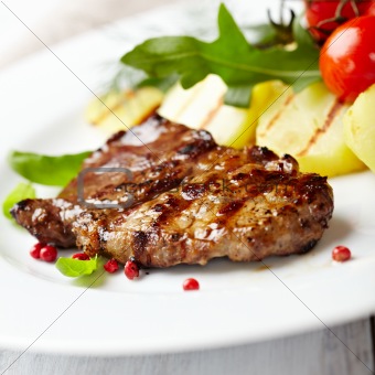 Gourmet grilled steak flavored with pink pepper and basil