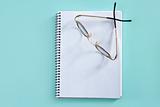 doctor teacher glasses on blank spiral notebook