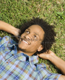 Man lying in grass.