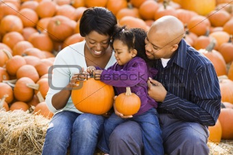 Family holding pumpkins.
