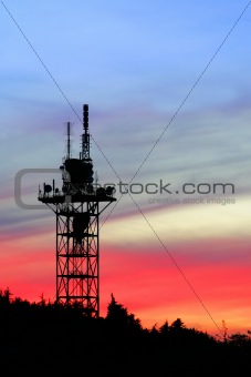 communication tower silhouette on sunset sky