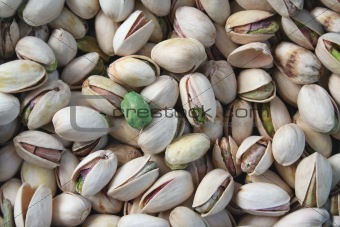 Pistachios with a single wasabi pea