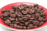 coffee beans on a red plate