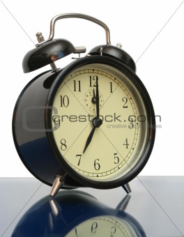Black alarm clock on a dark blue background