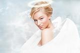 Gorgeous young woman as an angel with white wings and aureole