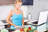 woman in kitchen with laptop