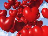 red heart shaped balloons floating in the sky