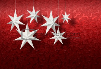 White paper stars on red brocade